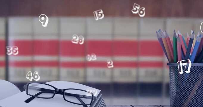 Animation of numbers over pencils and notebook with reading glasses in background