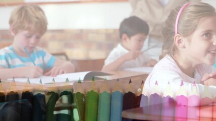 Animation of crayons over happy diverse pupils learning at school - Powered by Adobe