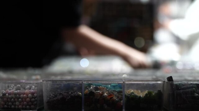 Woman chooses a bracelet made of natural stones. A fair or souvenir shop