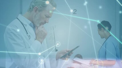 Animation of network of connections over thoughtful caucasian male doctor using digital tablet - Powered by Adobe