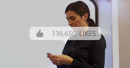 Animation of social media like notification over caucasian businesswoman using smartphone - Powered by Adobe