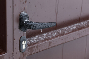 Frozen front door handle during winter cold temperatures