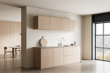 Minimalist light wood kitchen interior design with modern cabinets and natural lighting concept in...