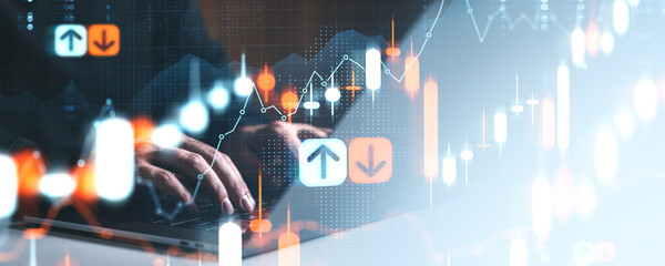 Hands on keyboard with glowing forex charts and rising market trend indicators in financial technology concept background.