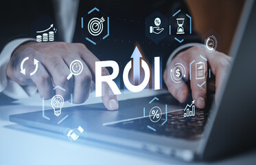 ROI concept with business icons and man working on laptop, symbolizing return on investment and financial growth on digital background.