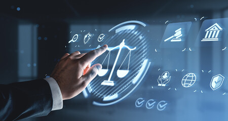 Hand interacting with digital justice scale interface on futuristic background symbolizing legal technology concept and innovation in digital law systems.