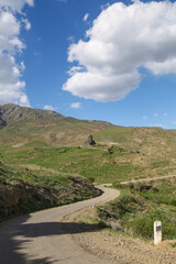 Scenic mountain road in Armenia passing through remote countryside landscapes. Rural travel route through village to Tanahat monastery, peaceful outdoor scenery 