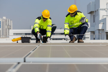 Fototapeta premium Engineers inspecting solar panels on rooftop