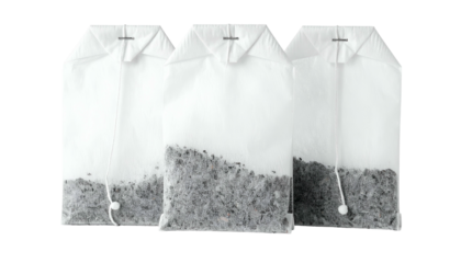 Three tea bags, filled with loose tea, are shown in an overhead, white-background shot