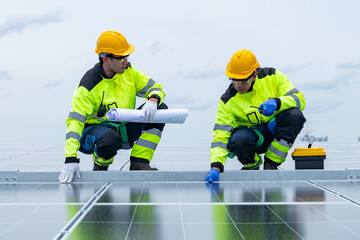 Fototapeta premium Engineers walking across rooftop solar panel array
