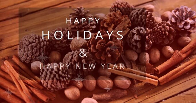 Animation of merry christmas text banner over pine cones and cinnamon sticks on wooden surface