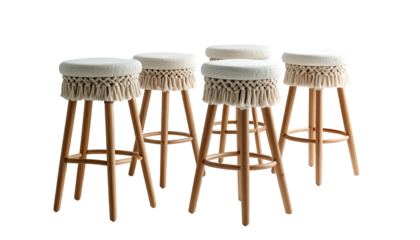 Group of five tall, wooden stools with cream seats and fringed edges, black backdrop