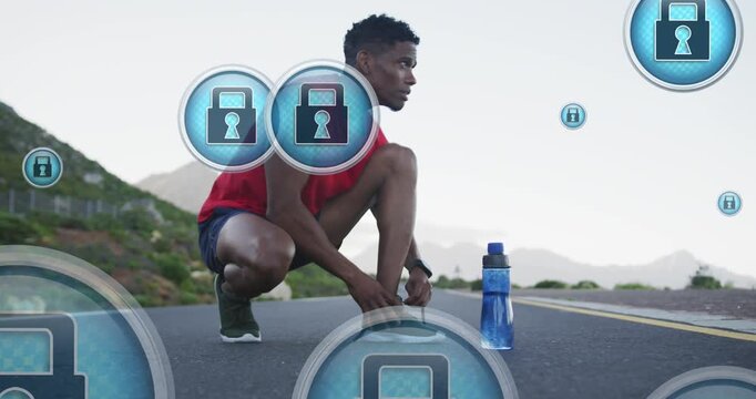 Animation of padlock icons, african american runner with bottle tying shoe lace on road