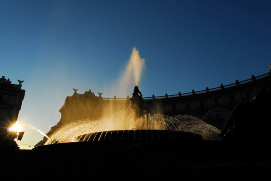 Fountain of the Naiads silhouette golden water jets at sunset. A monumental fountain completed in 1912 in the historic center of Rome