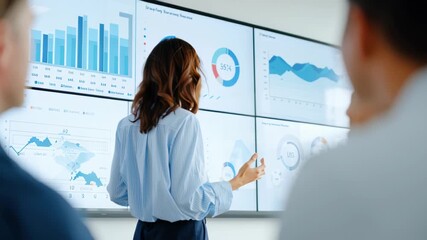 Business presentation with confident professional woman in front of data visualization screens in modern office - Powered by Adobe