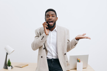 Confident smiling man talking on mobile phone indoors at workplace, casual business attire,...