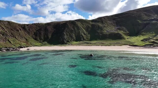 Drone flying toward remote sandy beach in the north-west Scottish Highlands, Wester Ross