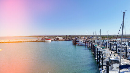 Fototapeta premium Drone shot of Exmouth harbor Western Australia capturing marina, coastline, and surrounding outback