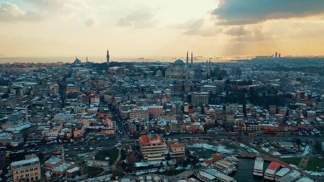 Istanbul Suleymaniye aerial view of the historic mosque complex covered in snow. Cinematic drone flight over the snowy landmark during winter.
