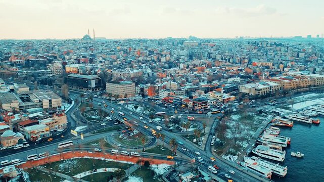 Istanbul Unkapani aerial view of Ataturk Bridge and traffic toward Eminonu and Balat. Cinematic drone flight over the snowy city and Golden Horn.