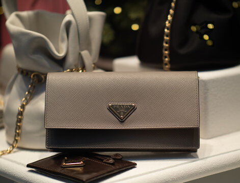Mini envelope bag in grey Saffiano leather. It is worn over the shoulder with a chain and features the Prada brand's triangular logo on the flap. Milan - Italy, 16 January 2026