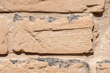 Tight Close-up View of a Wall Brick on which is Engraved in Babylonian cuneiform script, Iraq