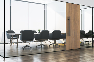 Fototapeta premium Modern conference room interior with glass walls, wood flooring, and city view through large windows in contemporary office setting. 3D Rendering