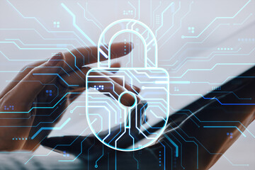 Cybersecurity concept with digital padlock overlay and hands using tablet on blurred background, symbolizing data protection and network safety.