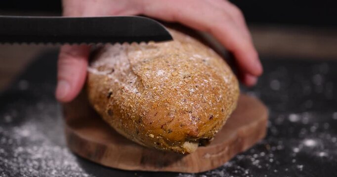 sliced fresh soft loaf of bread on slate, freshly baked soft loaf of rye bread cut in half