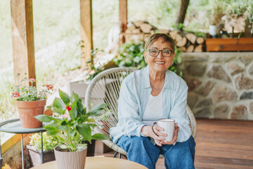 Stylish Senior Caucasian Woman Enjoying Coffee on Blooming Spring Veranda