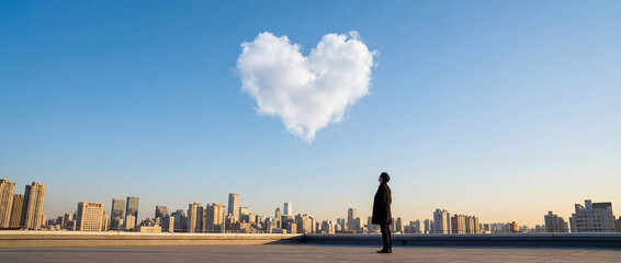 Man standing and gazing at heart-shaped cloud over cityscape  