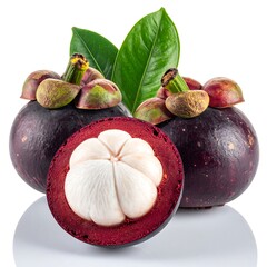 Mangosteens with leaves, one sliced showing white pulp, on white reflective surface