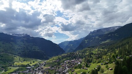 Fototapeta premium Walking route in Grindelwald with view of alpine town and surrounding mountains