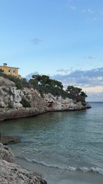 Empty Cala Ferrera beach in the evening panoramic view. Cala D'or on Mallorca in Spain.