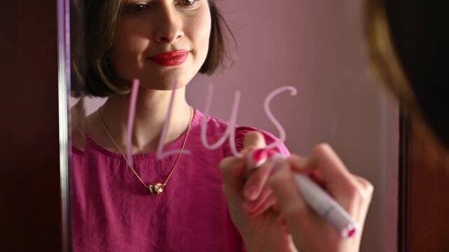 Love note. Girl Drawing ILU, lovely message on a Heart on a Mirror and Blowing a Kiss for Valentines day
