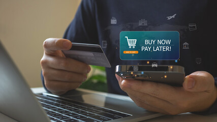 Buy now pay later.Man Hand Using Mobile Phone and credit card to Connect Mobile banking to shopping...