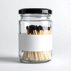 Matches in a glass jar with a black lid and blank white label on a white background