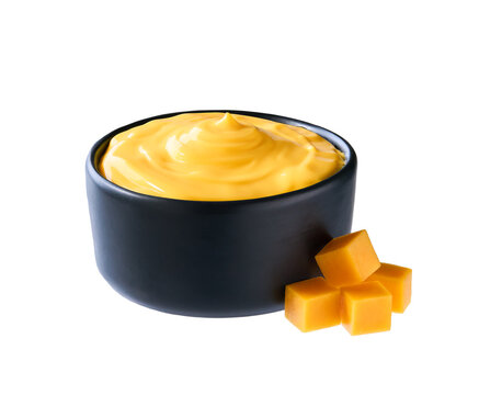 cheese sauce in a black bowl isolated on white background.
