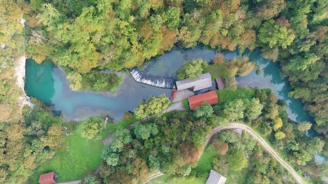River source and mill buildings aerial view