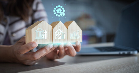 Woman holding wooden house models with digital icons representing property portfolio diversification across residential and commercial real estate assets, Economic trend, Real Estate Investment Trust