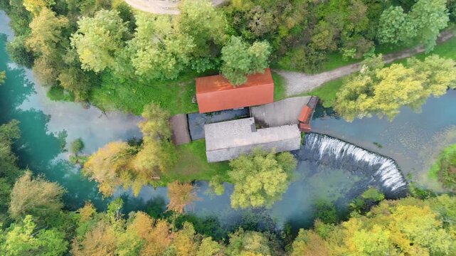 River source and buildings in autumn colors aerial view