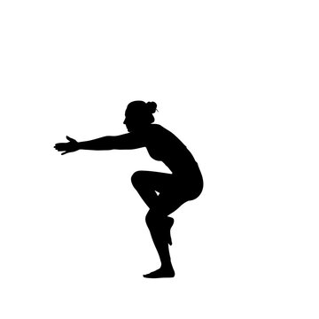 Silhouette of a woman in yoga eagle pose.