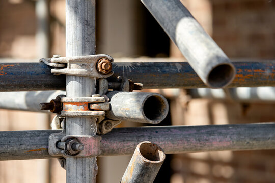 Close-up at scaffold parts, tubes and joints installed on building site