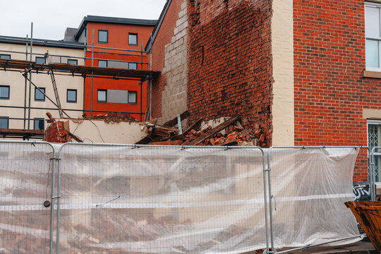 Construction work at a building site showing wall demolition in an urban area during daytime - Powered by Adobe