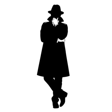 Silhouette of a mysterious person in a long coat and hat.