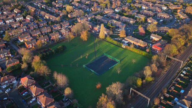 An elevated aerial video capturing the community green space of Marje Kelly Park in Gorse Hill, in Old Trafford - Greater Manchester. 
