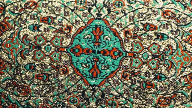 Detail of a traditional, handmade oriental silk rug. Texture of hand-woven rug, geometric patterns. High quality 4k footage