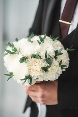 Close up of the bride's hands holding a bouquet of flowers. Bridal bouquet, hold the wedding bouquet in your hand