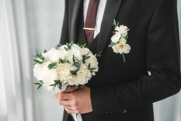 Close up of the bride's hands holding a bouquet of flowers. Bridal bouquet, hold the wedding bouquet in your hand