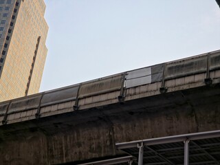 Low Angle View of Modern Corporate Skyscraper and Elevated Transit Track For Skytrain.